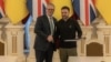 Ukraine's President Volodymyr Zelenskyy, right, shakes hands with Britain's Prime Minister Keir Starmer in Kyiv, Ukraine, after signing a 100-year agreement that pledges to strengthen defense ties between the two countries, Jan. 16, 2025.