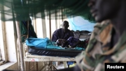 FILE - A child sick with malaria and from malnutrition lies on a bed in a hospital in Bor, South Sudan, March 15, 2014. 