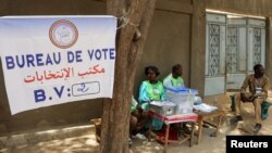 FILE — Electoral workers sit beside a ballot box at a polling station during the presidential election in N’djamena, Chad May 6, 2024.