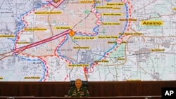FILE - Lt. Gen. Sergei Rudskoi of the Russian military's General Staff speaks, in front of a map of the Aleppo area in Syria, at a briefing at the Russian Defense Ministry's headquarters in Moscow, Russia, Oct. 19, 2016. Despite apparent evidence to the contrary, Russia is denying its troops are involved in ground operations in Syria.