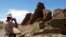 FILE - A tourist takes a picture of Anasazi ruins in Chaco Culture National Historical Park in New Mexico, Aug. 10, 2005.