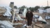 A Palestinian man inspects the damage at a tent camp sheltering displaced people, following an Israeli strike, amid the Israel-Hamas conflict, in al-Mawasi area, in Khan Younis, southern Gaza Strip, Jan. 2, 2025.