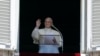 FILE - Pope Francis recites the Regina Coeli prayer from his studio's window overlooking St. Peter's Square at the Vatican, May 28, 2017.