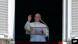 FILE - Pope Francis recites the Regina Coeli prayer from his studio's window overlooking St. Peter's Square at the Vatican, May 28, 2017.