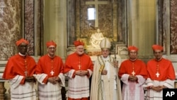 Pope Francis, center, poses in front of Michelangelo Buonarroti's Pieta' (The Pity) marble statue (AD 1499), with new Cardinals, from left, Jean Zerbo, Archbishop of Bamako, Malí, Juan José Omella, Archbishop of Barcelona Spain, Anders Arborelius, Bishop of Stockholm, Sweden, Louis-Marie Ling Mangkhanekhoun, Apostolic Vicary of Pakse, Laos, and Gregorio Rosa Chávez, Auxiliary of the dioceses of San Salvador, El Salvador, after the ceremony of their elevation in St. Peter's Basilica at the Vatican, June 28, 2017.