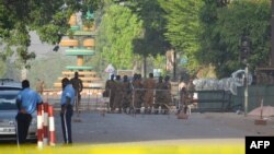 Military personnel stand outside the headquarters of the country's defence forces in Ouagadougou on March 3, 2018 a day after dozen of people were killed in twin attacks on the French embassy and the country's military.