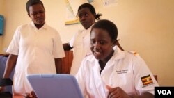 Rosemary Napeyok (right) in the Nadunget Health Center, located in Karamoja, northeastern Uganda, consults a doctor in Kampala over Skype, March 3, 2014. (Hilary Heuler for VOA News)