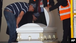 Lidia Gonzalez and Gilberto Gomez look at the body of their daughter Claudia Gomez Gonzalez, who was shot by a U.S. Border Patrol agent in Texas where she was trying to cross the border illegally, after her body was repatriated to Guatemala, May 31, 2018.