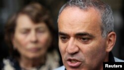 FILE - Former world chess champion and opposition leader Garry Kasparov speaks to the media after walking out of a court building in Moscow, Aug. 24, 2012. 