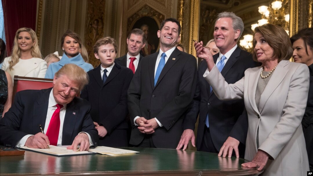 President Donald Trump is joined by the Congressional leadership and his family as he formally signs his cabinet nominations into law, in the President's Room of the Senate, at the Capitol in Washington, Jan. 20, 2017. 