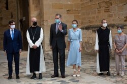 Spain's Health Minister Salvador Illa, left, Spain's King Felipe VI, third left, and Queen Letizia, third right, visit the Royal Monastery of Poblet, northeastern Spain, July 20, 2020.