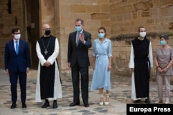 Spain's Health Minister Salvador Illa, left, Spain's King Felipe VI, third left, and Queen Letizia, third right, visit the Royal Monastery of Poblet, northeastern Spain, July 20, 2020.