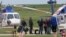 Workers disembark from a helicopter after being evacuated from oil production platforms ahead of Tropical Storm Cristobal, at Bristow Galliano Heliport in Galliano, La., June 6, 2020. 