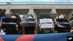 FILE - Supporters of Hong Kong protesters stage a rally calling for a boycott of the Disney-produced film "Mulan" outside Walt Disney Korea office in Seoul, South Korea, July 1, 2020.