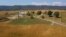 An aerial photo shows farm buildings and a farm house surrounded by a crop of corn on a farm owned by the family of West Virginia Governor Jim Justice.