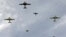 WWII-era Dakotas drop paratroopers near Normandy village of Ecausseville, western France, June 7, 2014.