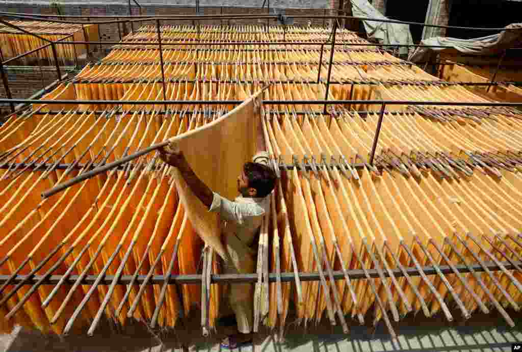 A vendor arranges traditional vermicelli noodles, a favorite during the Muslim holy fasting month of Ramadan, at a factory, in Lahore, Pakistan. 
