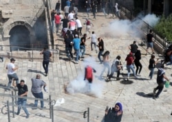 Palestinian protesters participate during a demonstration to show their solidarity amid Israel-Gaza fighting, at Jerusalem's Old City, May 18, 2021.
