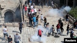 Palestinian protesters participate during a demonstration to show their solidarity amid Israel-Gaza fighting, at Jerusalem's Old City, May 18, 2021.