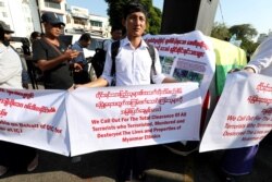 A Myanmar nationalist group gathers to protest against Gambia and Organization of Islamic Cooperation for accusing Myanmar of committing genocide over Rohingya minority in Rakhine state in Yangon, Myanmar, Nov. 25, 2019.