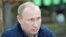 Russia's President Vladimir Putin meets with members of the Russian Geographical Society's expedition on the Gogland Island in the Gulf of Finland in the Baltic Sea, July 15, 2013. 