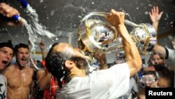 Los Angeles Galaxy forward Landon Donovan (10) celebrates by drinking out of the MLS Cup championship trophy in the locker room after defeating the New England Revolution in the 2014 MLS Cup final at Stubhub Center, Dec. 7, 2014. Credit: Gary A. Vasquez-U