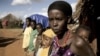 FILE - A women and her children stand next to their house on the outskirts of Moyale, Ethiopia, a nation where not many books are written in local languages, and few Ethiopians read for pleasure.