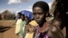 Karsi Tadicha and her children stand next to their house in Bule Duba village, on the outskirts of Moyale, Ethiopia, June 2009.