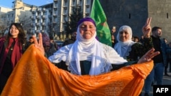 A supporter flashes a victory sign after the jailed leader of the Kurdistan Workers' Party, Abdullah Ocalan, called on the party to disarm and dissolve itself, in Diyarbakir, Turkey, Feb. 27, 2025.