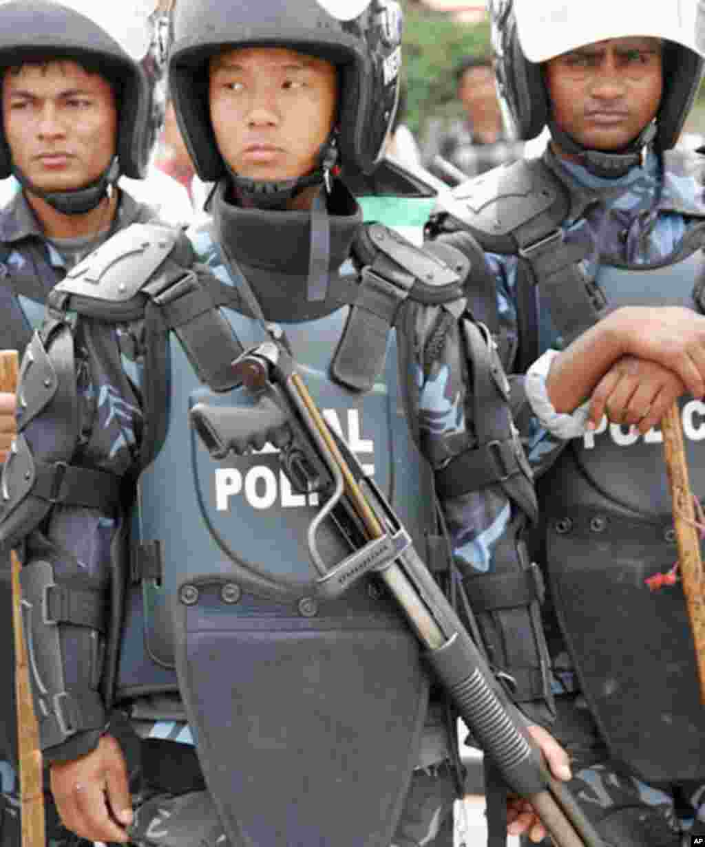 Although the Army is not visible some of the police on the streets have shotguns and rifles