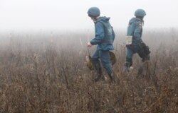 Members of the Emergencies Ministry of the separatist Donetsk People's Republic remove mines from the area near the settlement of Petrovskoye (Petrivske) in the Donetsk region, Ukraine, Nov. 19, 2019.
