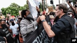 Protesters march past City Hall on June 2, 2020, in Philadelphia, over the death of George Floyd, who died after being restrained by Minneapolis police officers on May 25.