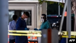  Healthcare workers prepare for testing at a "walk-in" and "drive-through" coronavirus testing site in Miami Beach, Florida on June 24, 2020.