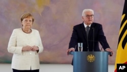 German Chancellor Angela Merkel (CDU, l) stands next to Federal President Frank-Walter Steinmeier, right, in Bellevue Castle in Berlin, Thurday, June 27, 2019.