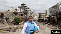 Yacoub El Hillo, a United Nations representative in Syria, reacts to the camera in old Homs city May 8, 2014. 