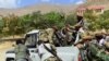 FILE - Militiamen loyal to Ahmad Massoud push a vehicle during a training exercise, in Panjshir province, northeastern Afghanistan, Aug. 30, 2021.