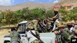 FILE - Militiamen loyal to Ahmad Massoud push a vehicle during a training exercise, in Panjshir province, northeastern Afghanistan, Aug. 30, 2021.