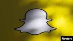 FILE - A billboard displays the logo of Snapchat above Times Square in New York.