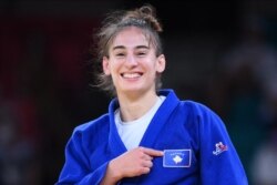 Kosovo's Nora Gjakova celebrates winning the judo women's -57kg final bout against France's Sarah Leonie Cysique during the Tokyo 2020 Olympic Games, July 26, 2021.