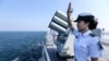 FILE - A Chinese soldier waves farewell to Russian fleets as the Chinese-Russian joint naval drill concludes in Zhanjiang, Guangdong Province, China.