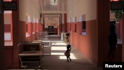 A toddler runs through Chiulo Hospital in Cunene province, Angola, Feb. 24, 2018.