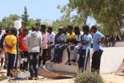 Survivors evacuated the crumbled detention center and spent the night outside while officials searched for the injured and the dead on July 3, 2019 in Tripoli, Libya. (H. Murdock)