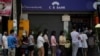 FILE - People line up outside a bank branch in Yangon, Myanmar, Feb. 1, 2021.