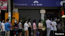 FILE - People line up outside a bank branch in Yangon, Myanmar, Feb. 1, 2021.