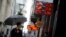 People walk by a money exchange house in downtown Buenos Aires, Argentina, May 4, 2018. 