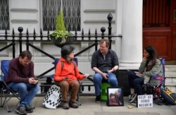 FILE - Richard Ratcliffe, the husband of jailed British-Iranian aid worker Nazanin Zaghari-Ratcliffe speaks with supporters as he stages a vigil and goes on hunger strike outside of the Iranian embassy in London, June 15, 2019.