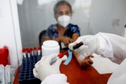 Norma Gonzalez, 68, waits for results after she was tested for the COVID-19 virus, in a Red Cross laboratory in Tegucigalpa, Honduras, April 23, 2021.