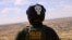 A U.S. Border Patrol agent, wearing a helmet while riding an ATV, searches for migrants trying to enter the United States from the Mexico border in a desert area in Sunland Park, New Mexico, on Aug. 17, 2023.