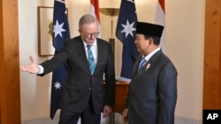 Indonesia's President-elect Prabowo Subianto, right, is greeted by Australian Prime Minister Anthony Albanese at Parliament House in Canberra, Australia, Aug. 20, 2024. 