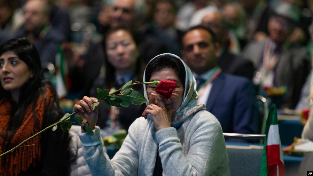 One of the Iranian Americans supporting the National Council of Resistance of Iran holds a single rose at their '2020 LA Convention for Free Iran' at the Los Angeles Convention Center on Saturday, Jan. 11, 2020.